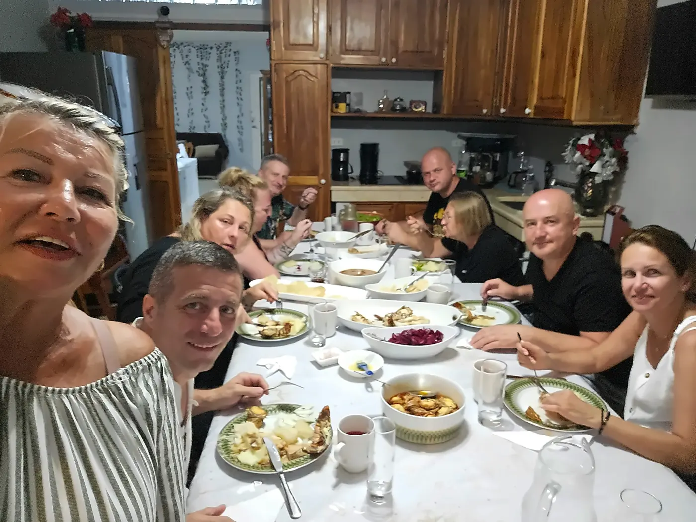 The table laid and full of people, inside the house